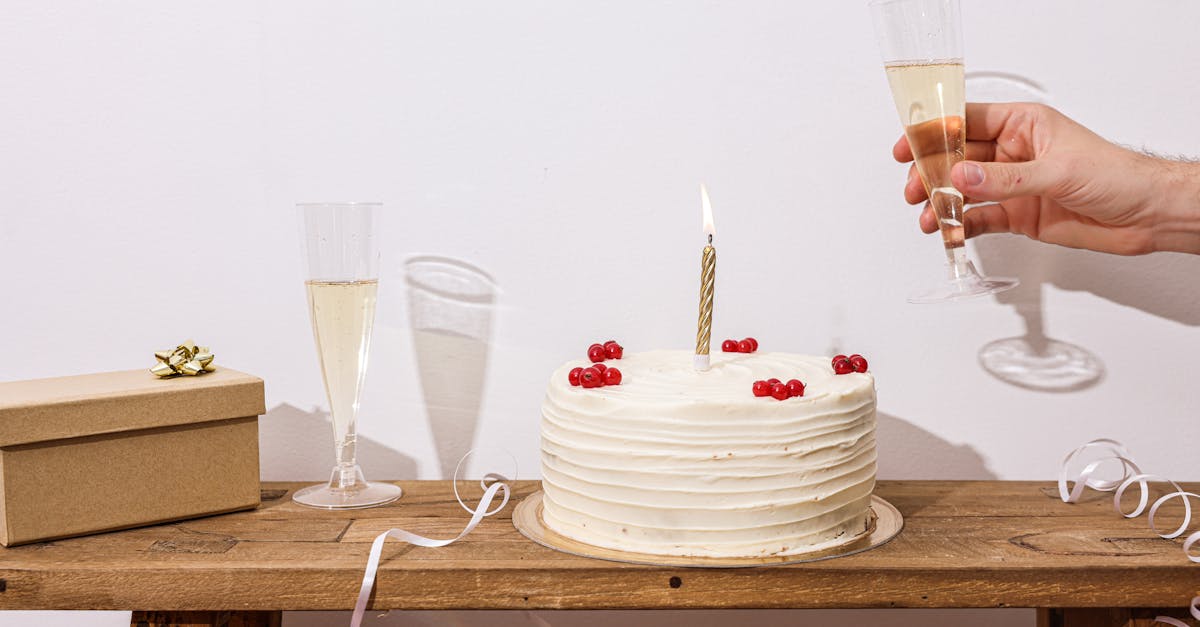 A festive scene with a cake, champagne, and a gift box perfect for celebrations.