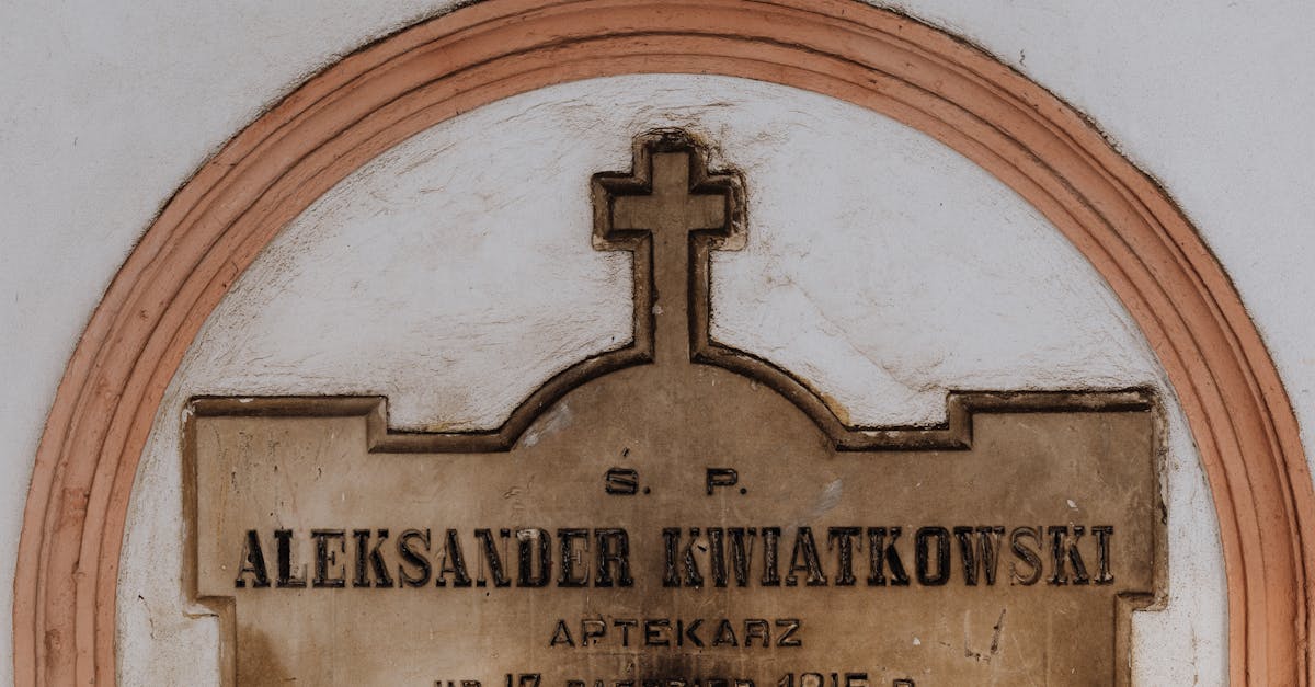 Close-up of a historic tombstone with engraved cross and text, depicting a memorial from 1815-1873.