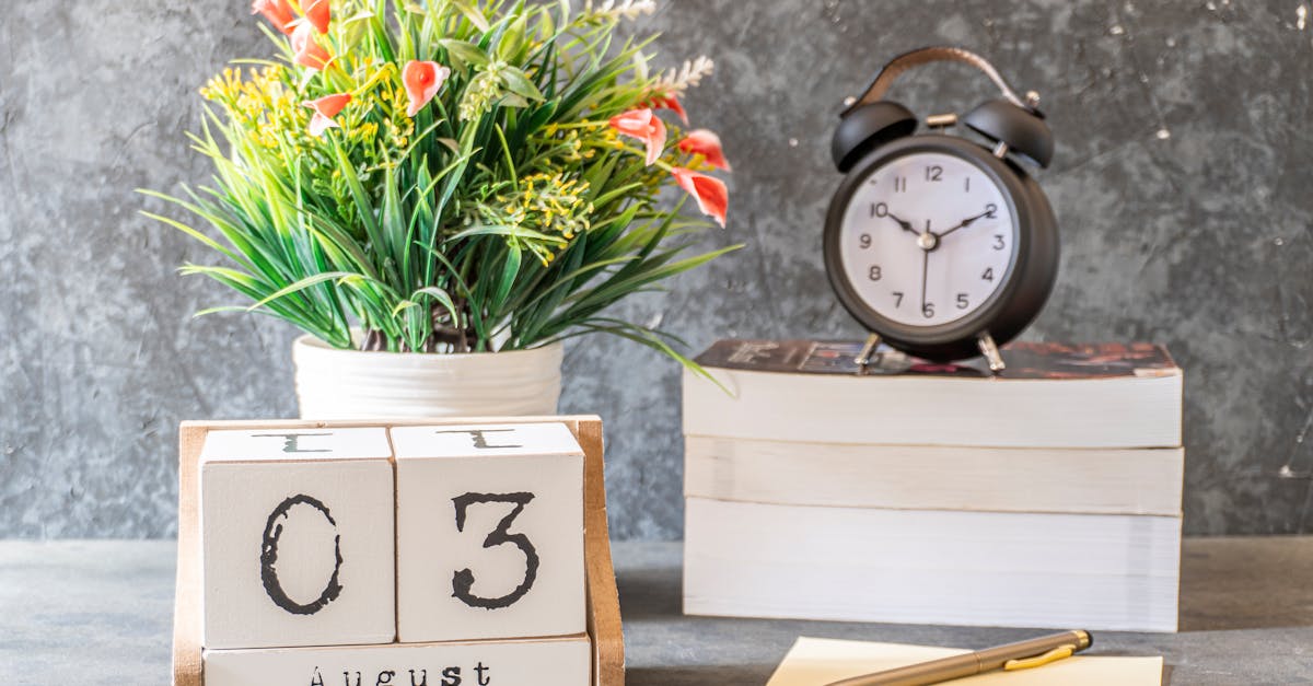 Stylish August 3rd setup with a vintage clock, flower arrangement, and calendar blocks on a desk.