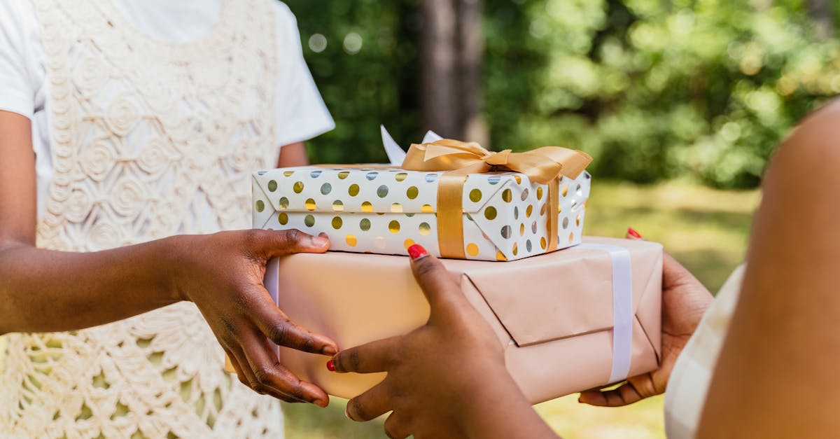 Two individuals exchanging colorfully wrapped gift boxes in a lush outdoor setting, symbolizing celebration.