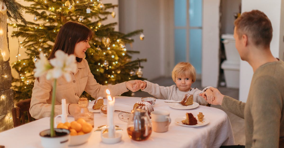 Family enjoying a festive meal by a Christmas tree, sharing love and togetherness.