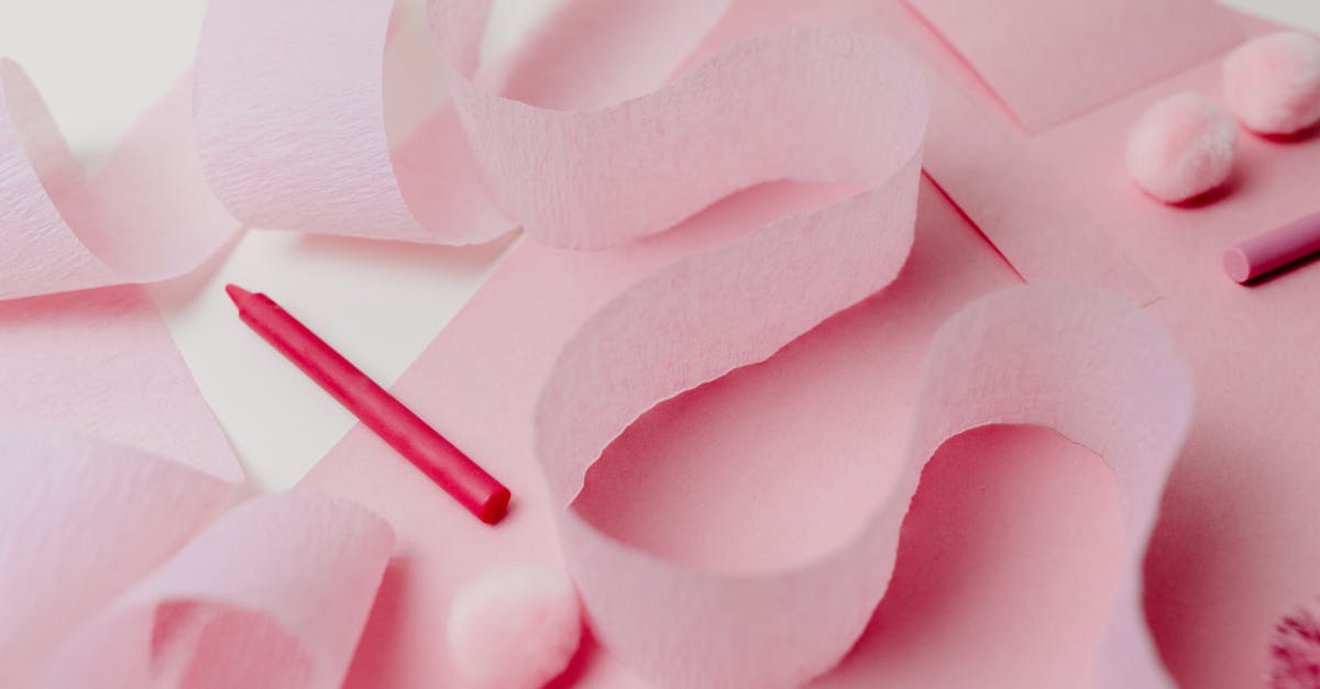 A pastel pink flat lay featuring craft supplies, perfect for party decoration and creative projects.