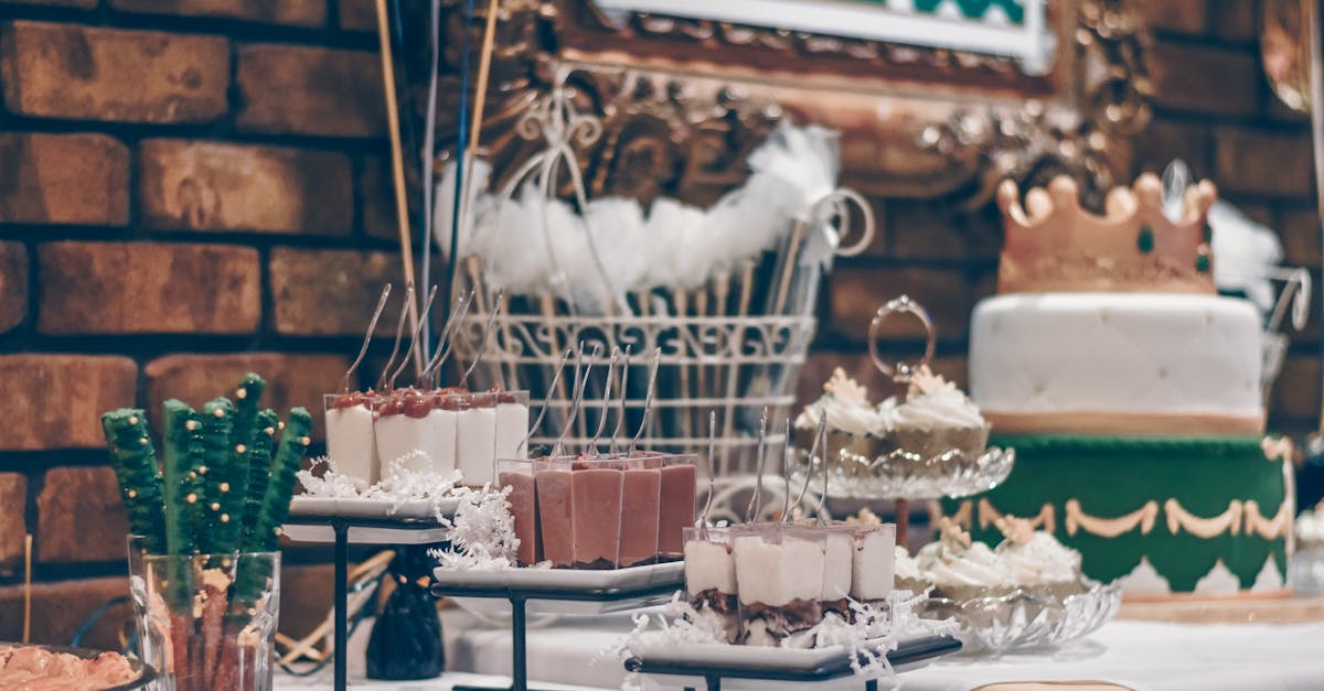 Beautifully decorated dessert table featuring cake and assorted sweets at a celebration event.