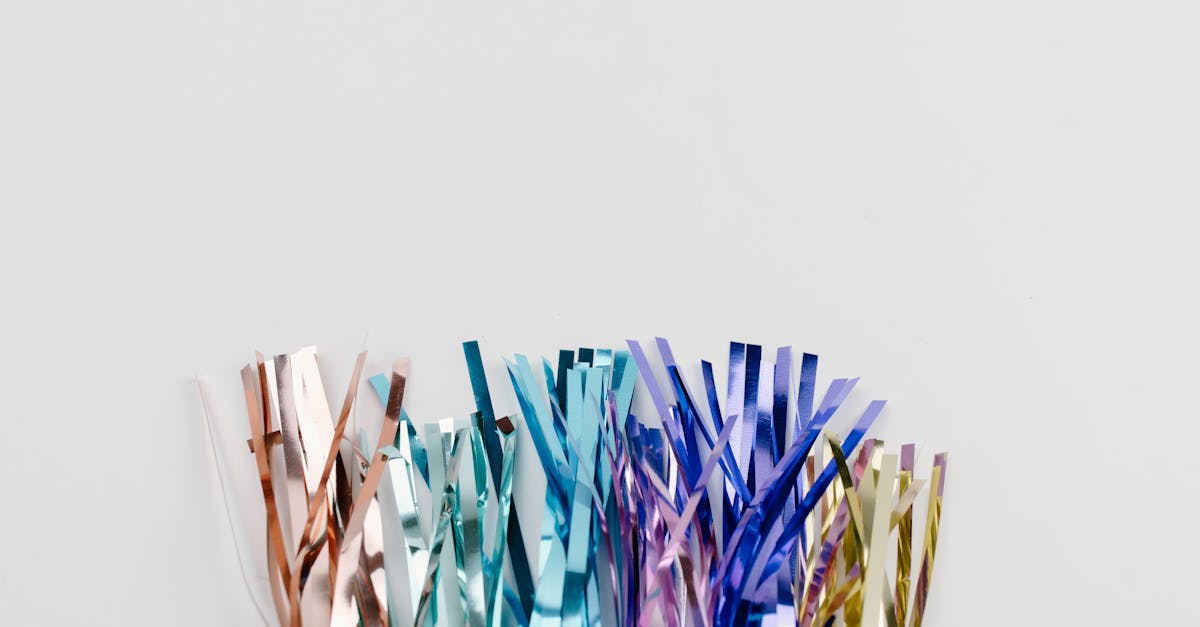 Close-up of colorful metallic confetti tinsel against a plain white background, perfect for celebrations.